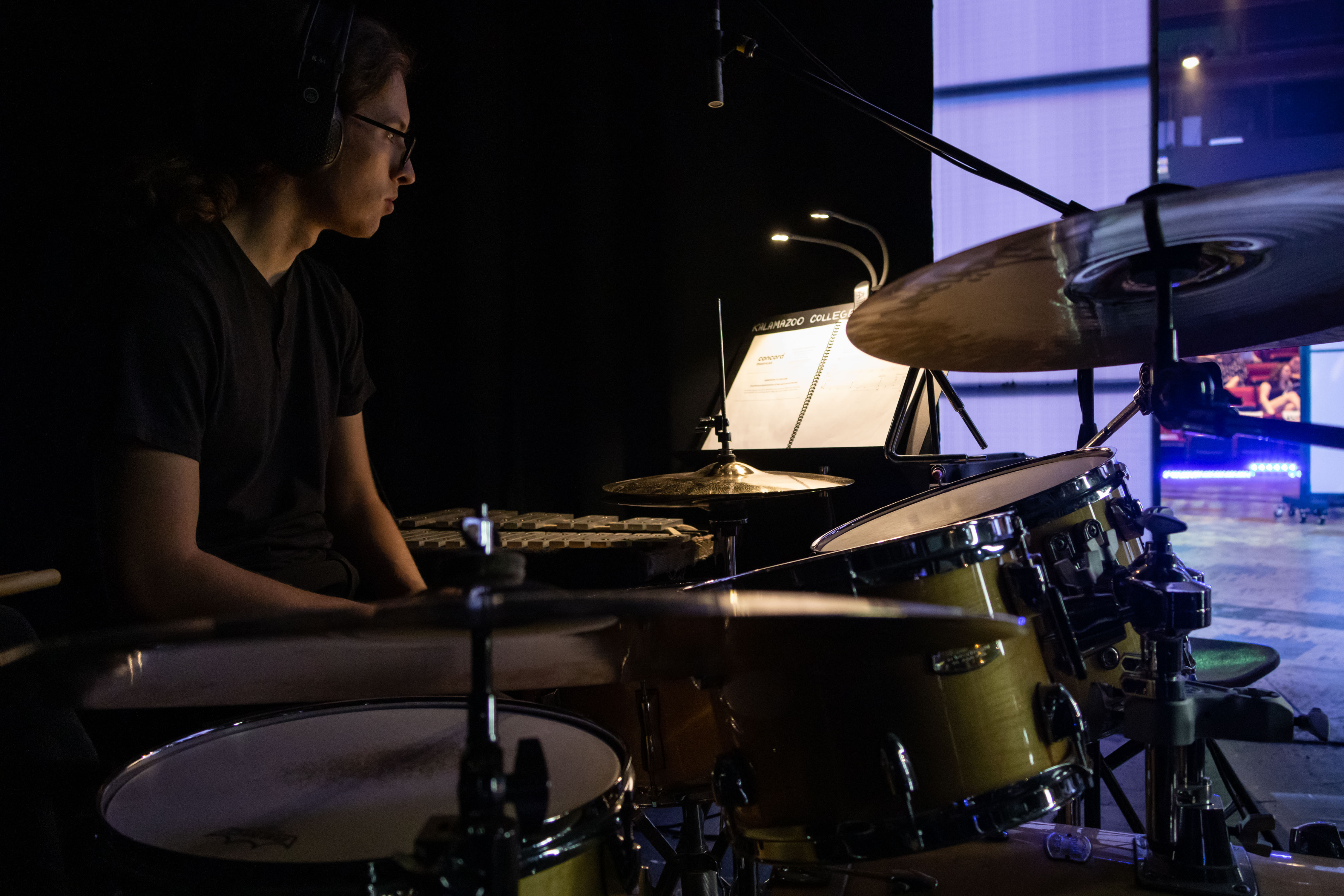 Photo of Xavier Silva drumming during Kalamazoo College's 2024 production of 'Be More Chill'.